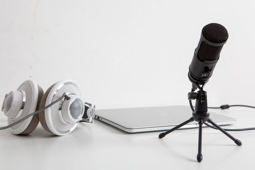 Headphones, Microphone and Laptop on White Desk